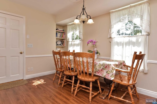 dining space featuring a chandelier and wood-type flooring