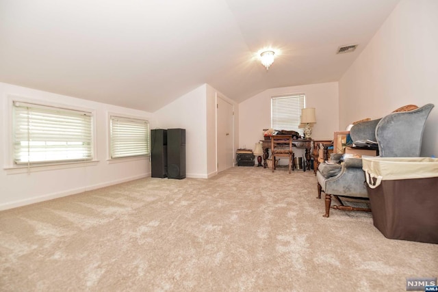 sitting room featuring light colored carpet and vaulted ceiling