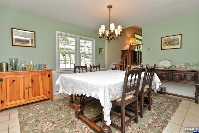 tiled dining area with a notable chandelier