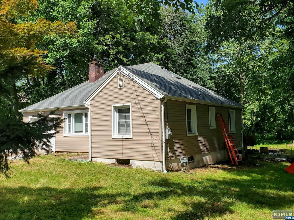 view of side of property with a yard