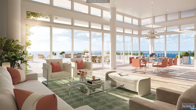 sunroom with a water view and a notable chandelier