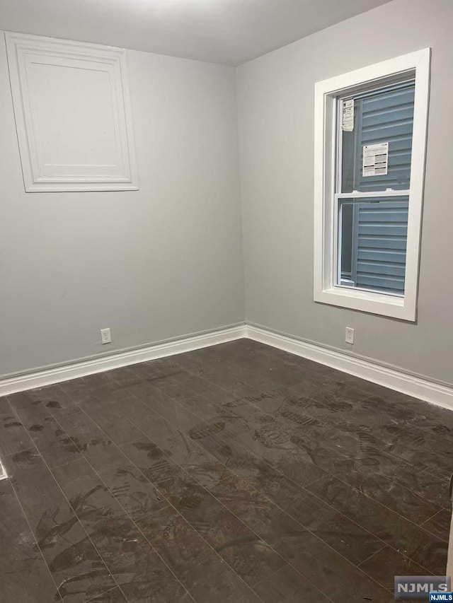 unfurnished room featuring dark hardwood / wood-style floors