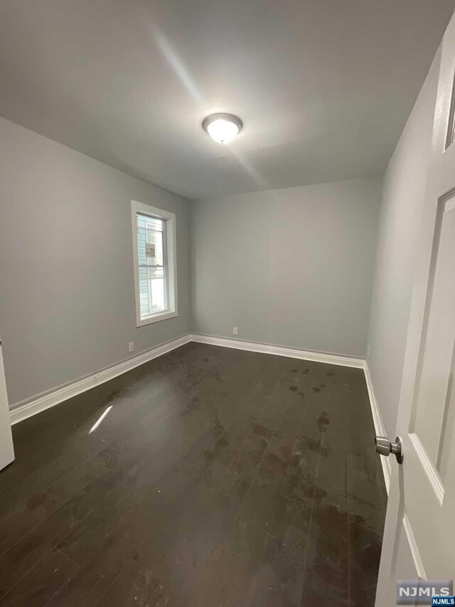 empty room featuring dark hardwood / wood-style floors