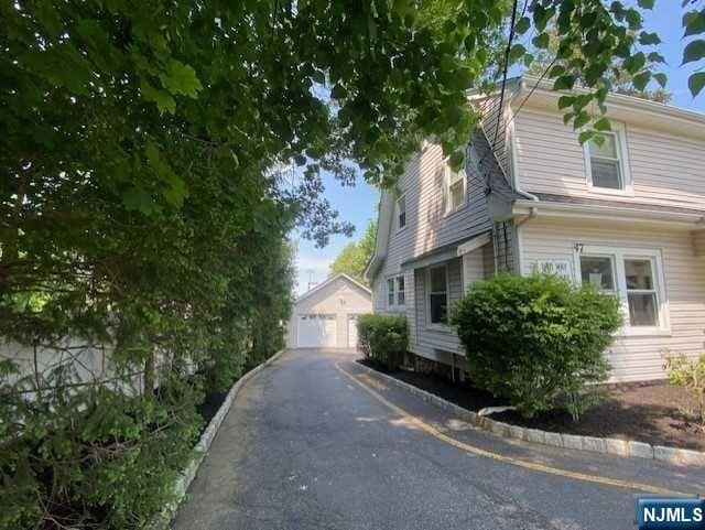 view of property exterior featuring an outbuilding and a garage