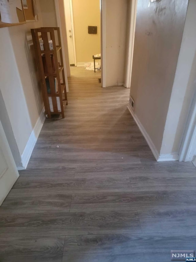 hallway featuring dark hardwood / wood-style floors