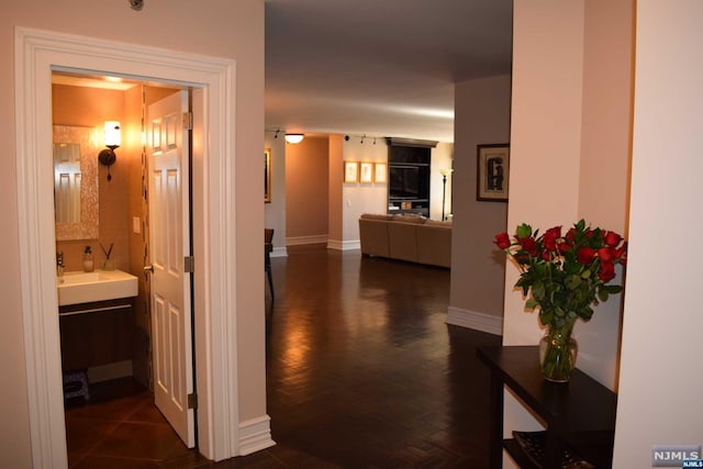 hallway with dark hardwood / wood-style floors