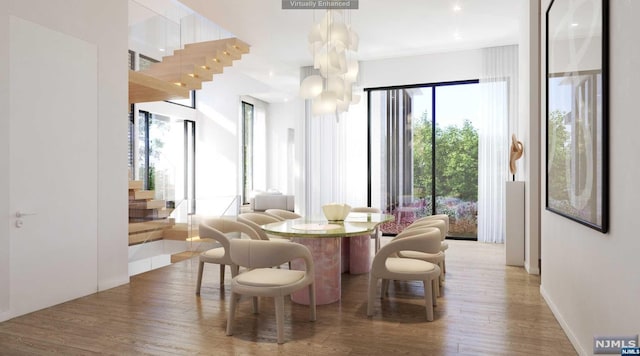 dining area with wood-type flooring and a notable chandelier