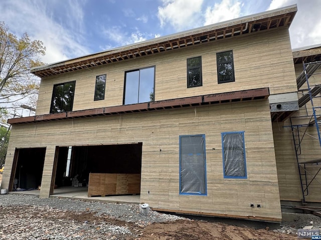 rear view of property featuring a garage