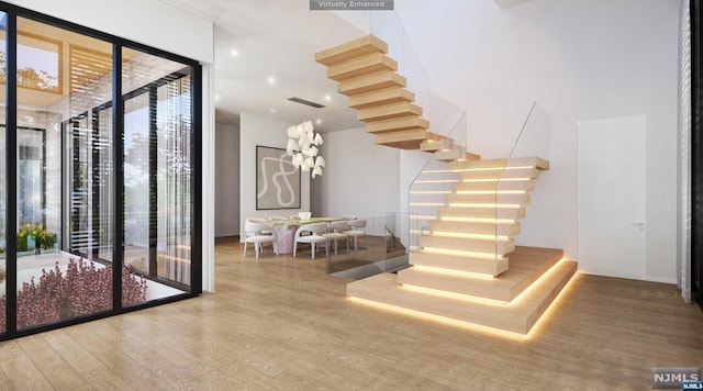 stairs with hardwood / wood-style floors