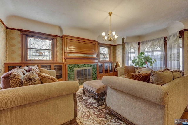 living room featuring a fireplace and a notable chandelier