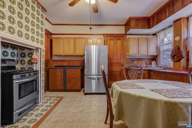 kitchen featuring ceiling fan, ornamental molding, and appliances with stainless steel finishes