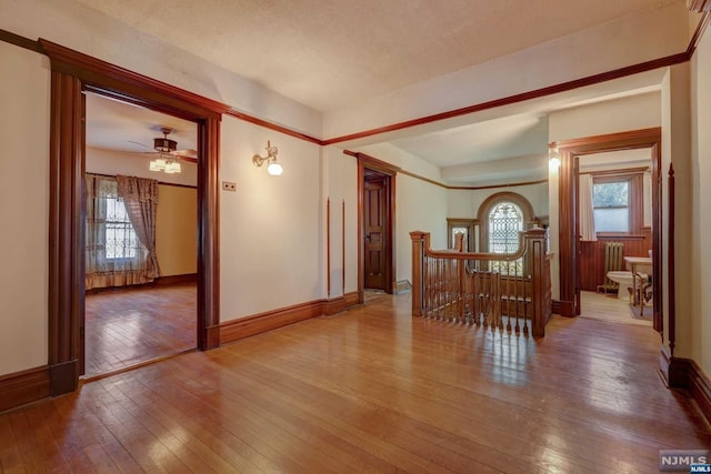 spare room with ceiling fan, hardwood / wood-style floors, and a textured ceiling