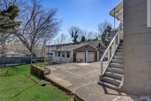 back of property featuring a yard and a garage