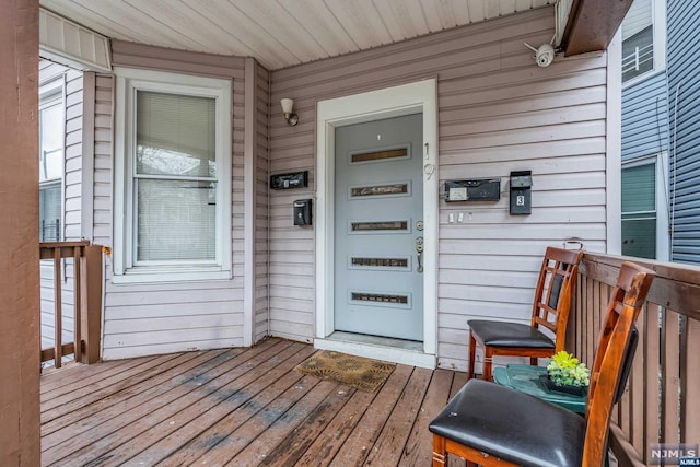 property entrance featuring a wooden deck