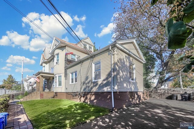 view of side of home with a lawn