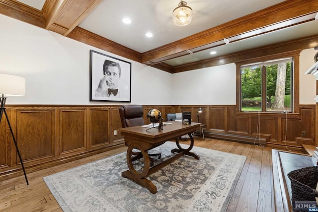 office featuring beam ceiling, ornamental molding, baseboard heating, and light hardwood / wood-style flooring