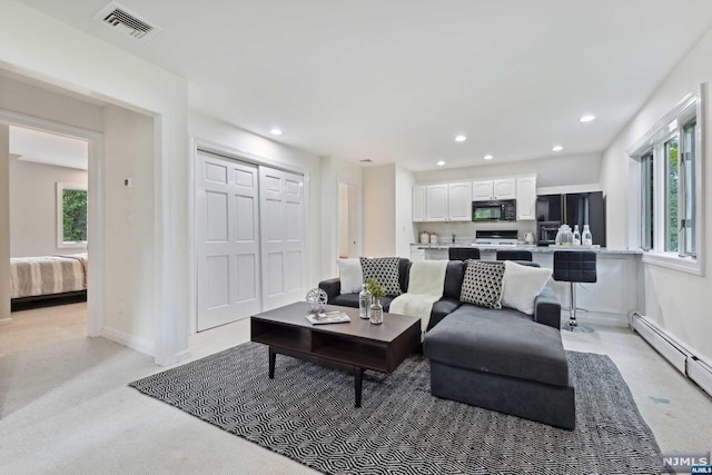 carpeted living room with a baseboard radiator