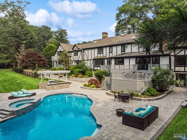 view of pool with an in ground hot tub, a pergola, a deck, an outdoor fire pit, and a patio