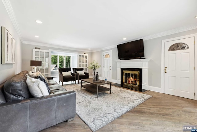 living room with ornamental molding and hardwood / wood-style flooring