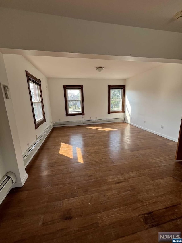 bonus room featuring plenty of natural light, dark hardwood / wood-style flooring, and a baseboard radiator