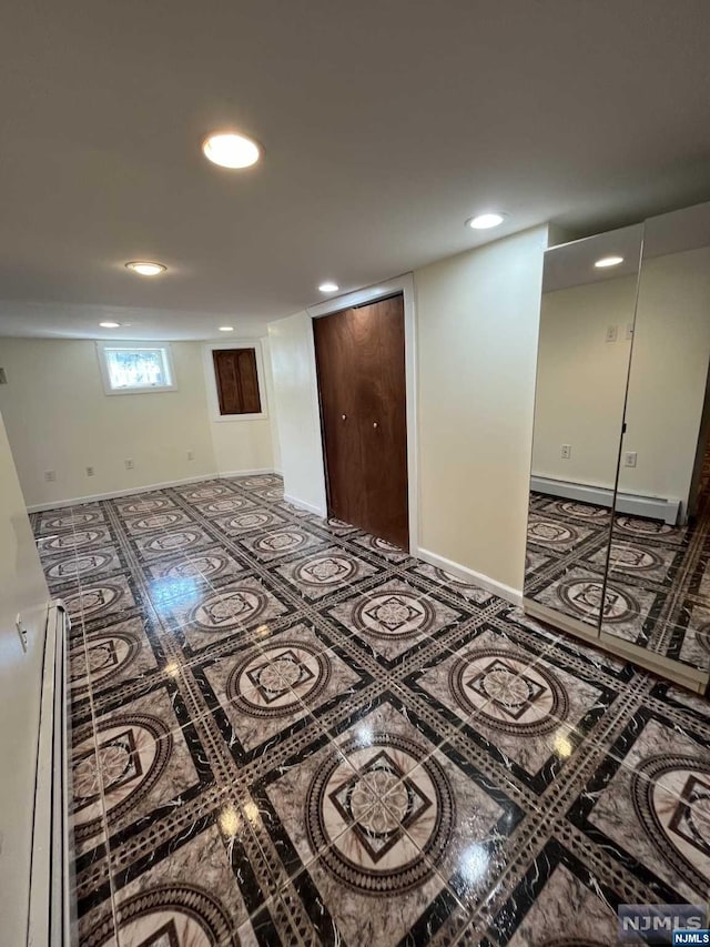 basement featuring a baseboard heating unit