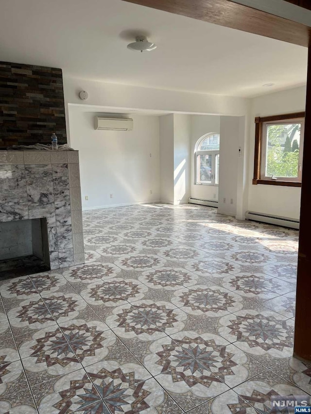 unfurnished living room with a wall unit AC, a baseboard heating unit, and a tiled fireplace