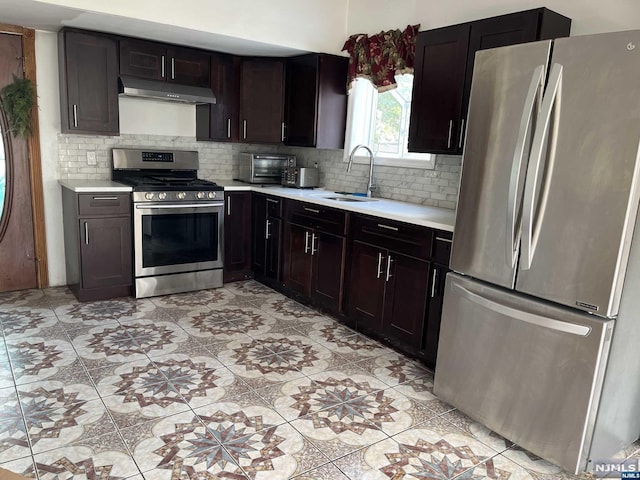 kitchen featuring light tile patterned floors, backsplash, stainless steel appliances, and sink