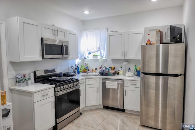 kitchen featuring white cabinets, sink, and appliances with stainless steel finishes