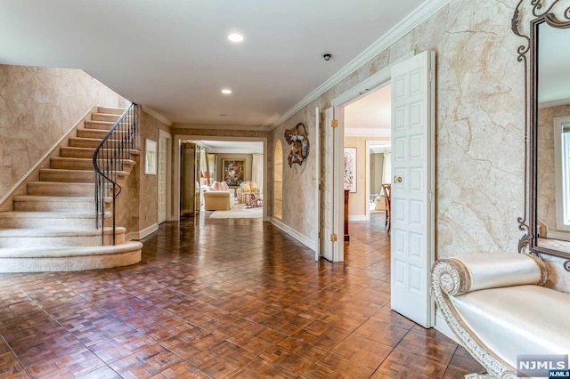 foyer featuring dark parquet floors and crown molding