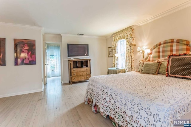 bedroom featuring hardwood / wood-style floors and crown molding