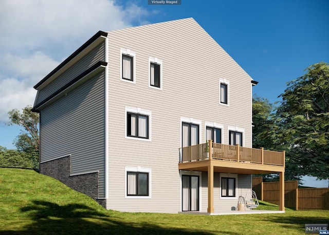 back of house with a yard, a balcony, and a patio