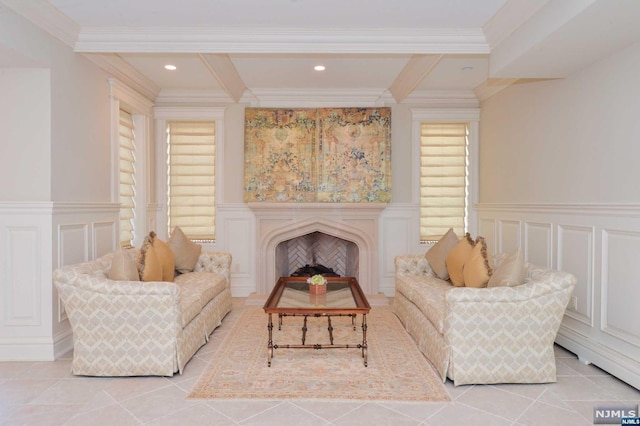 sitting room with beamed ceiling, light tile patterned flooring, and ornamental molding