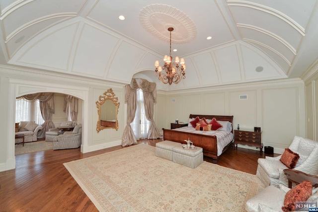 bedroom featuring a notable chandelier, dark hardwood / wood-style floors, and crown molding