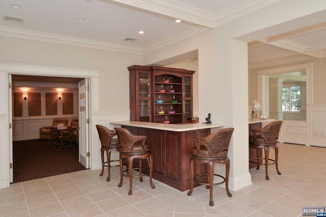 bar with light tile patterned floors and ornamental molding