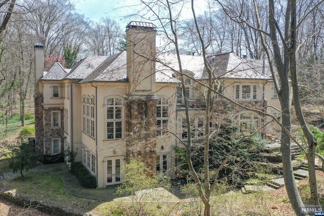 rear view of property featuring french doors