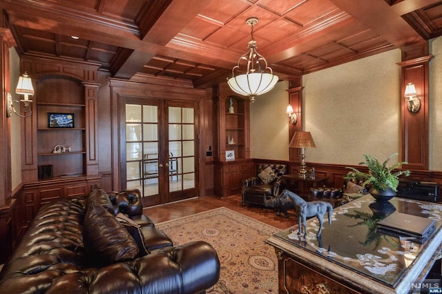 living room featuring french doors, ornate columns, coffered ceiling, crown molding, and beam ceiling