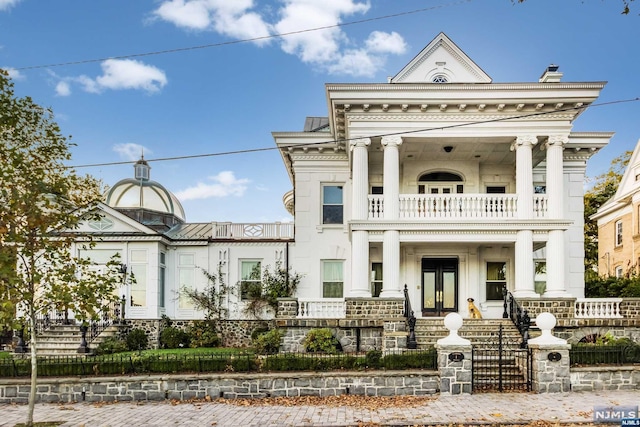 greek revival house with a porch and a balcony