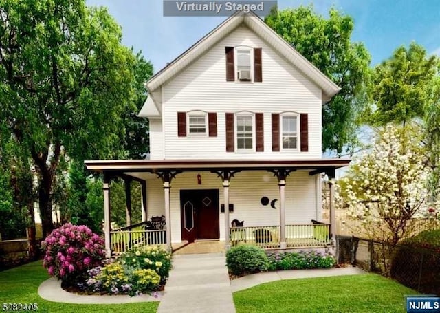 view of front facade with covered porch and a front lawn