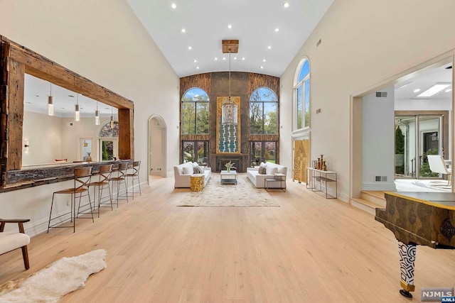 interior space featuring light hardwood / wood-style flooring and high vaulted ceiling