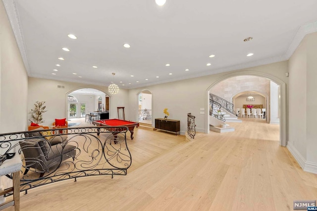 recreation room with light hardwood / wood-style floors, ornamental molding, and pool table