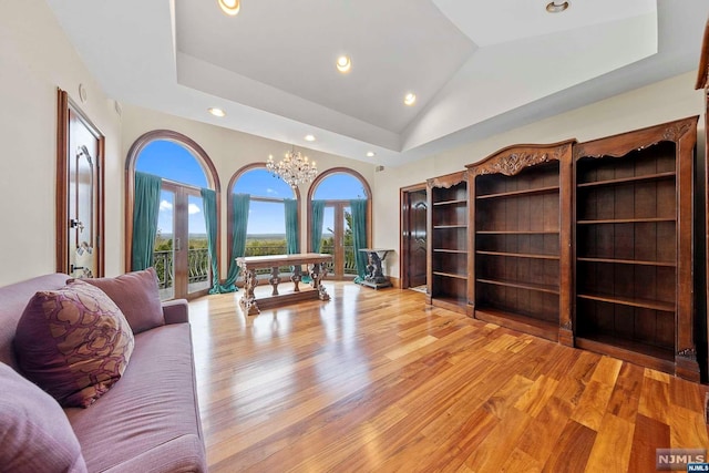 office with an inviting chandelier, light wood-type flooring, french doors, and vaulted ceiling