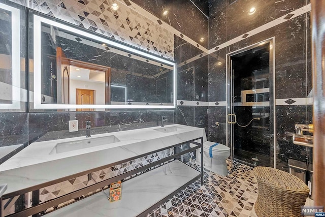 bathroom with decorative backsplash, walk in shower, vanity, tile walls, and toilet