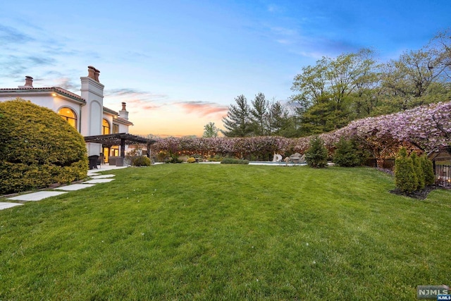 view of yard at dusk