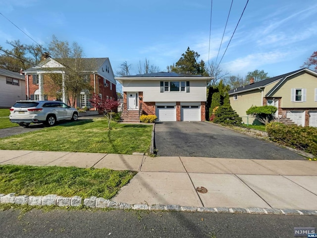 view of front of house with a garage and a front yard