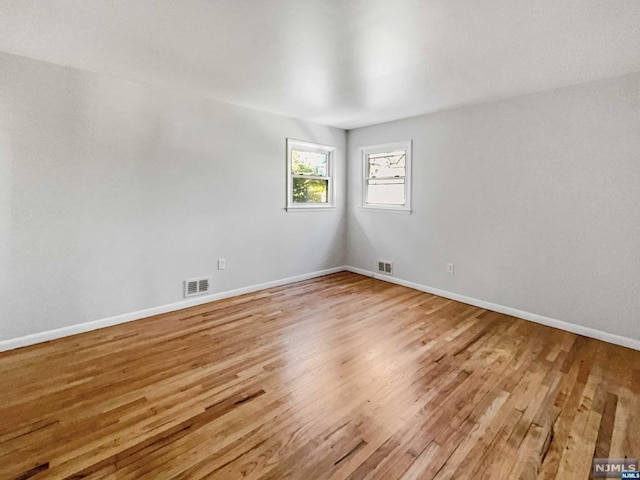 spare room featuring hardwood / wood-style flooring