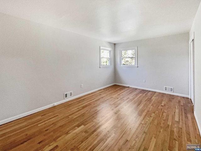 empty room with light hardwood / wood-style flooring