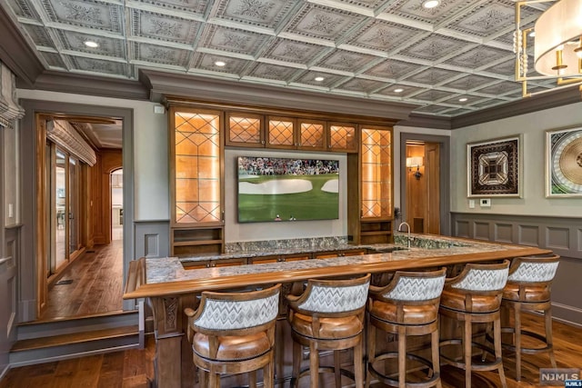 bar featuring crown molding, dark hardwood / wood-style flooring, and coffered ceiling