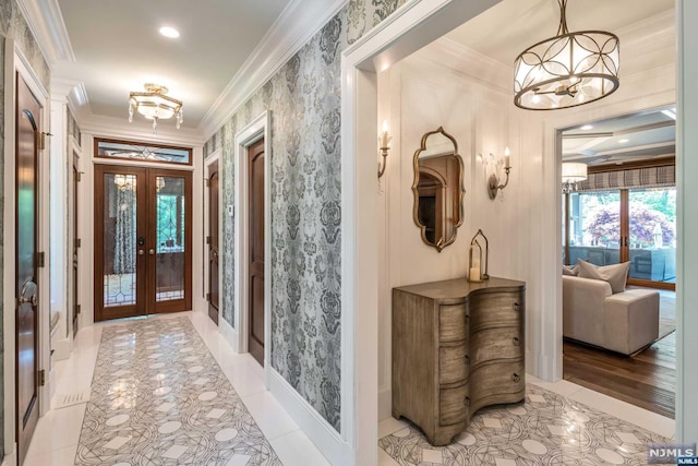 interior space featuring an inviting chandelier, crown molding, and french doors