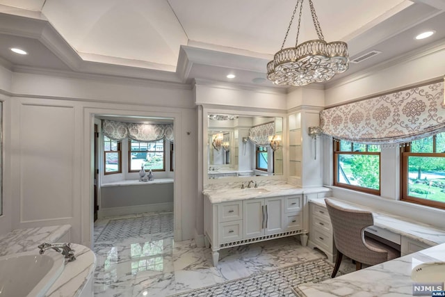 bathroom with ornamental molding, vanity, a wealth of natural light, and a tub