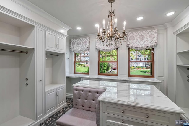 walk in closet featuring a chandelier